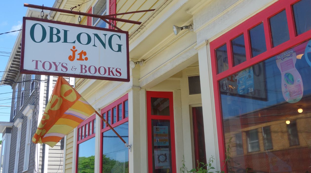 The yellow exterior and the colorful sign at Oblong Books, Millerton